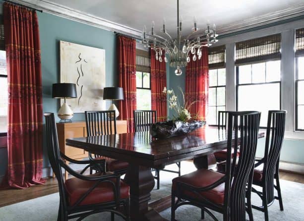 blue walls and red curtains in an eclectic dining room