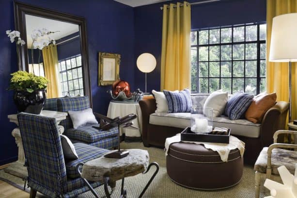 bright yellow curtains on vibrant and a bit dark blue walls in an eclectic living room