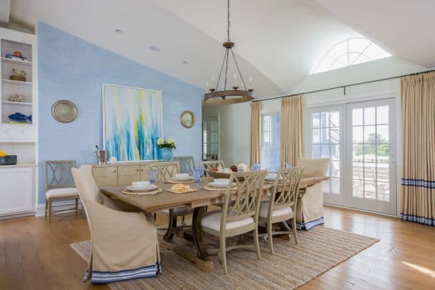 sky blue and white walls and linen white curtains in a beach-style dining room