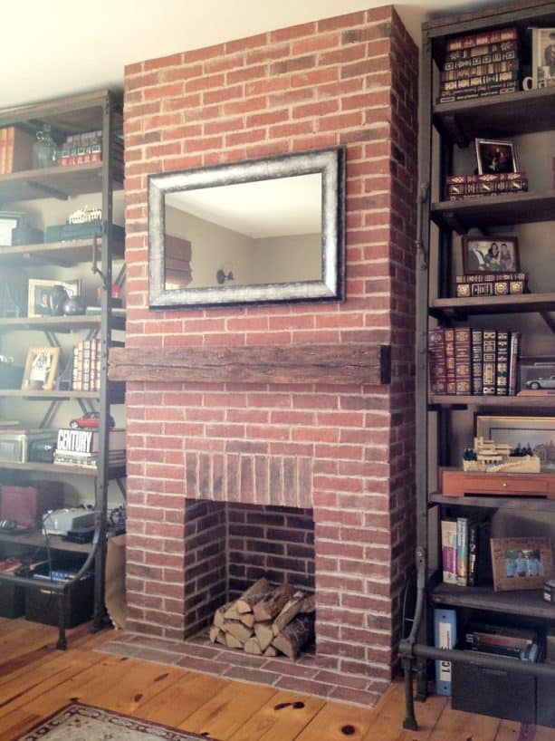 a fireplace covered in thin brick tiles in a traditional family room