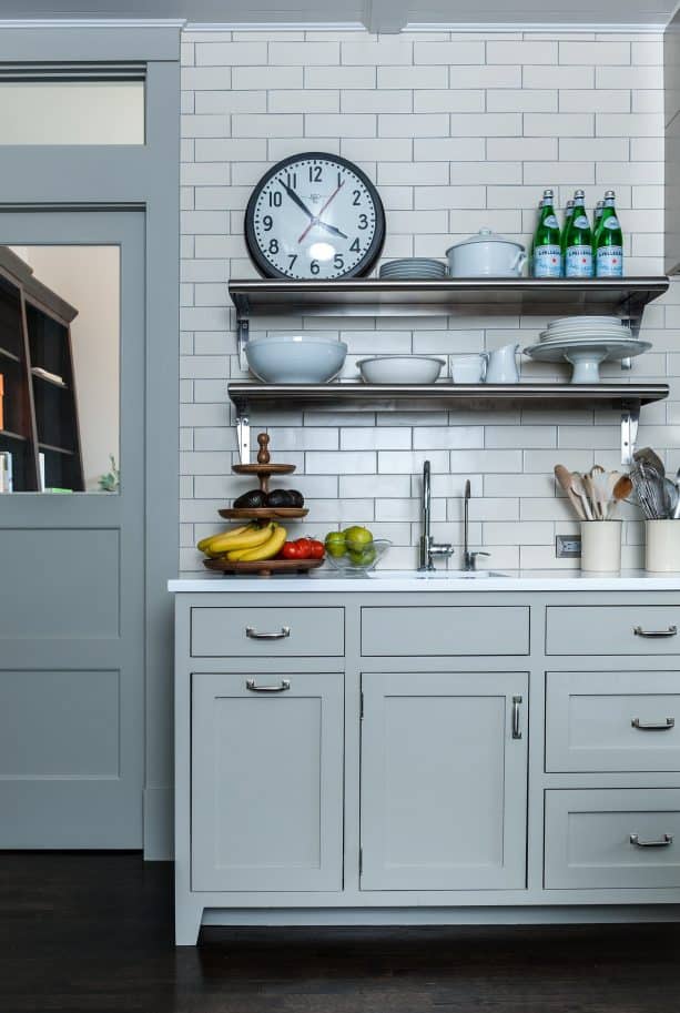 wall-size kitchen backsplash with white subway-style tile and grey grout