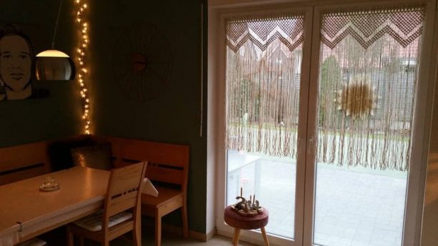 white macramé curtains as glass door covering