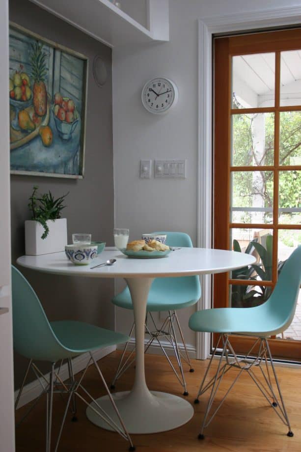 pastel turquoise chairs and grey walls in a transitional dining room