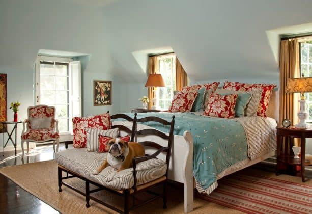 turquoise bed cover and red pillows