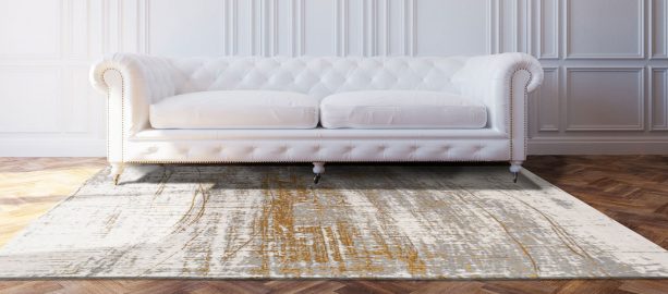 contemporary white, gold, and grey area rug in a luxurious living room