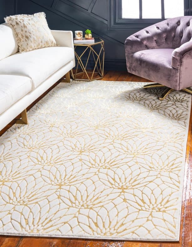 white and gold flower area rug in a living room
