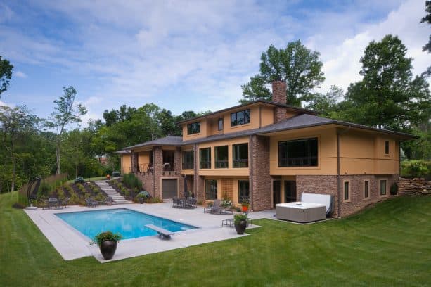 a contemporary walkout basement patio that is connected directly to a swimming pool