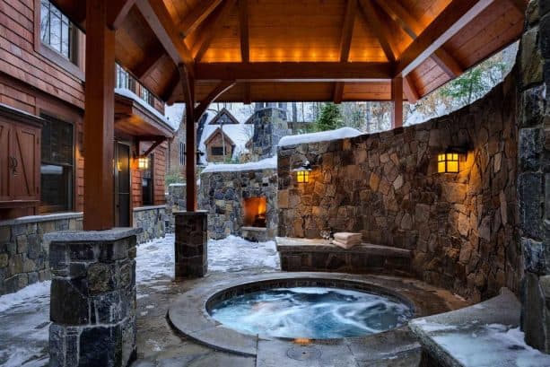 a hot tub in a sunken covered walkout basement patio