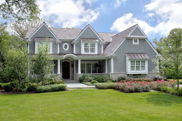a light grey traditional house with light grey roof