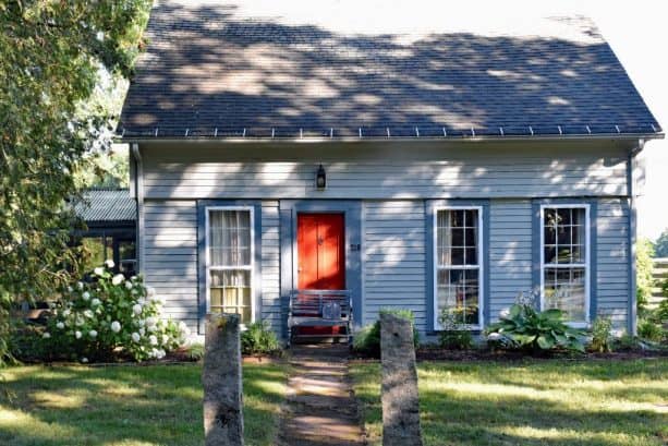 a slate blue house with crimson red door