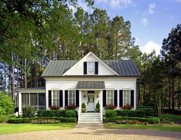 a small charming guest house with black shutters for the windows