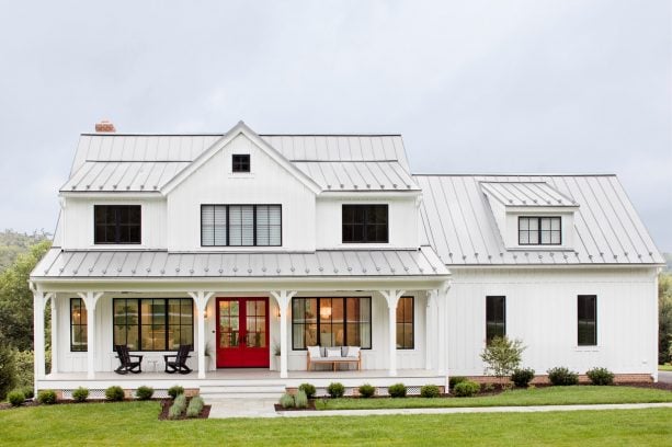 a white farmhouse with metal roof