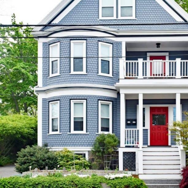 stone blue house with denim blue window trim and blood red doors