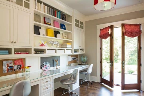 a traditional home office with glass-wood doors and white trim