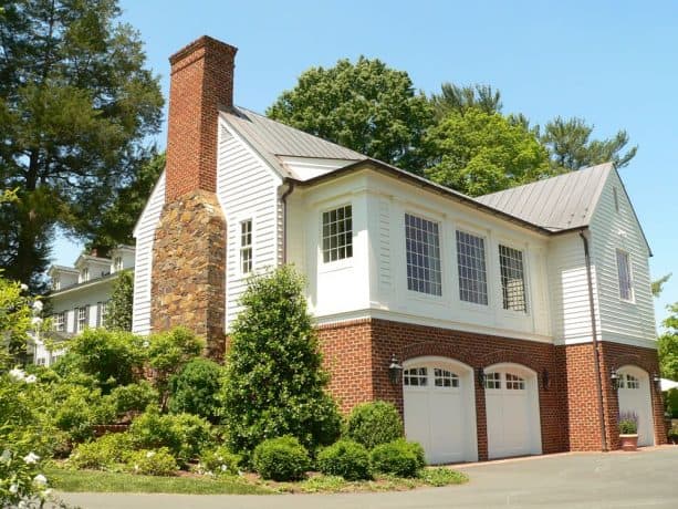 a classic, timeless exterior look created by using half white siding and half red brick materials