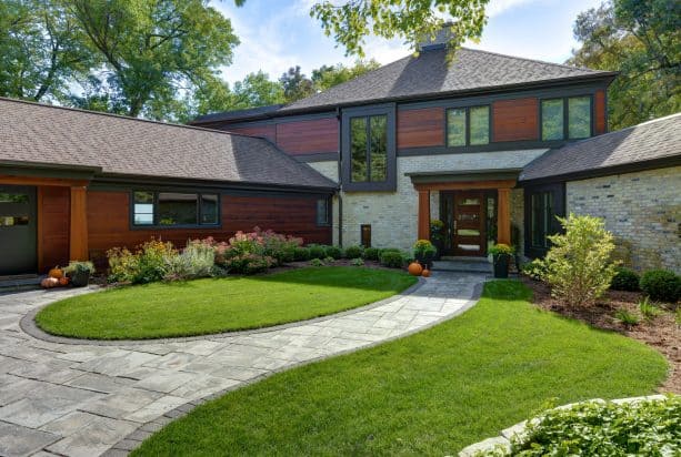 an aesthetic and elegant light contemporary exterior with the combination of dark-stained wood siding and tan brick