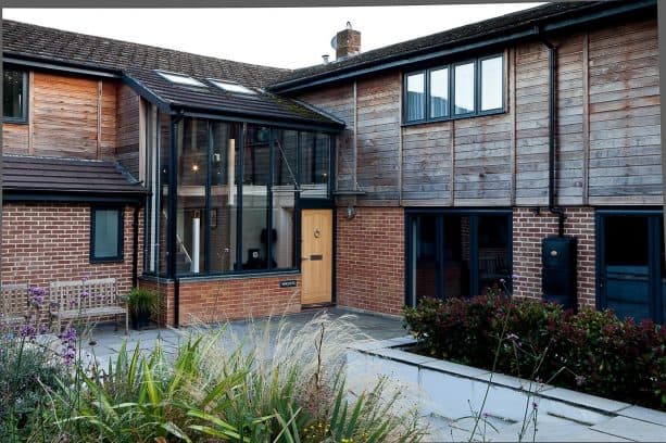natural wood siding for adding a rustic feel in your half brick exterior