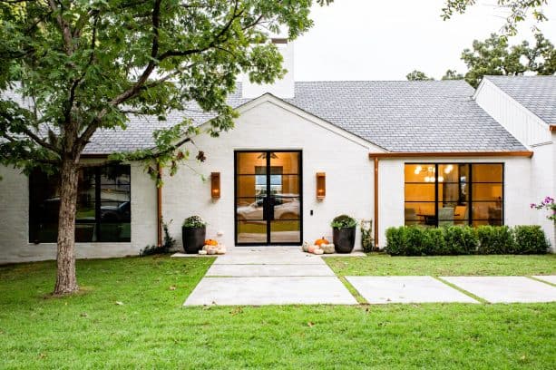 white-painted brick paired with black and copper color in a ranch-style exterior color scheme