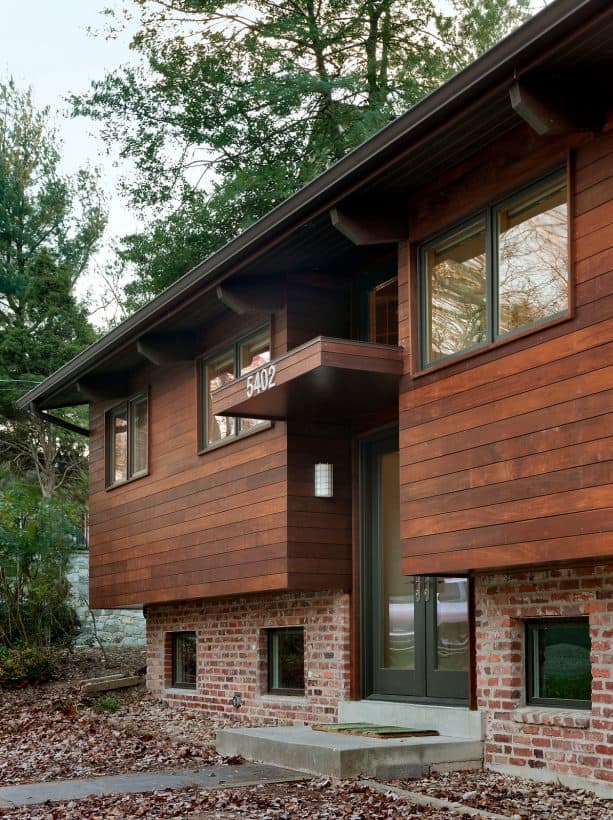 wider wood stained wood siding paired with old orange brick in a contemporary home exterior