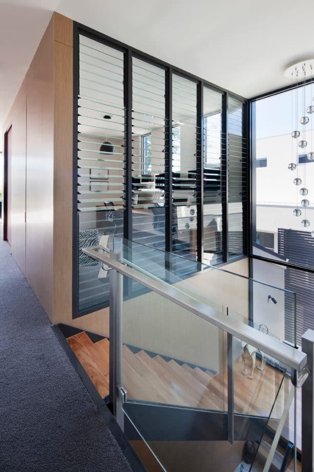 a home office with louvered glass interior windows