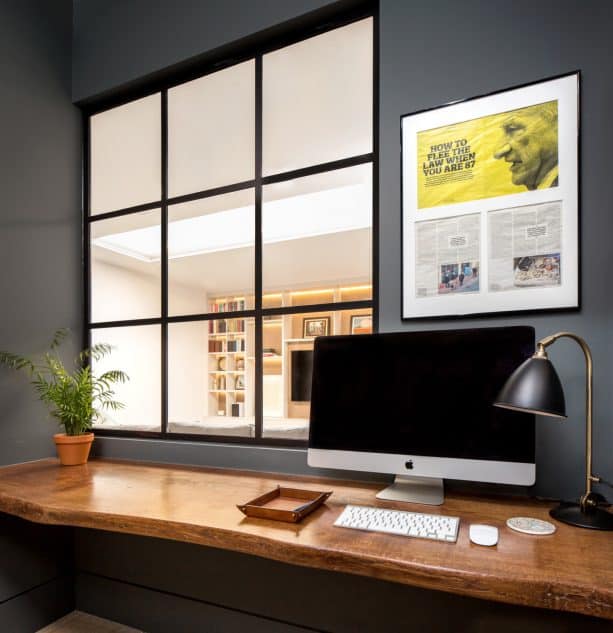 a small home office with glass interior window