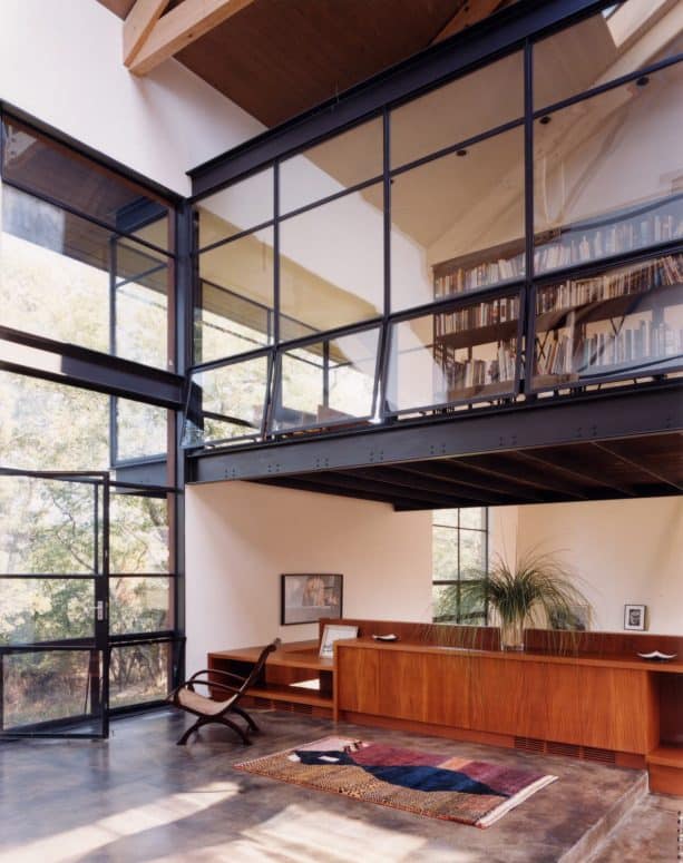 contemporary home office and library with interior windows with opening