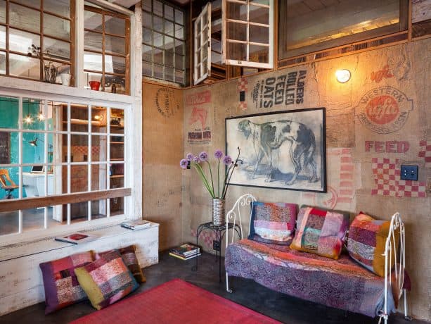 gorgeous eclectic interior with opening reclaimed windows on the upper wall