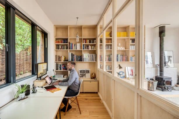 home office with permanent wooden partition that comes with glass window feature