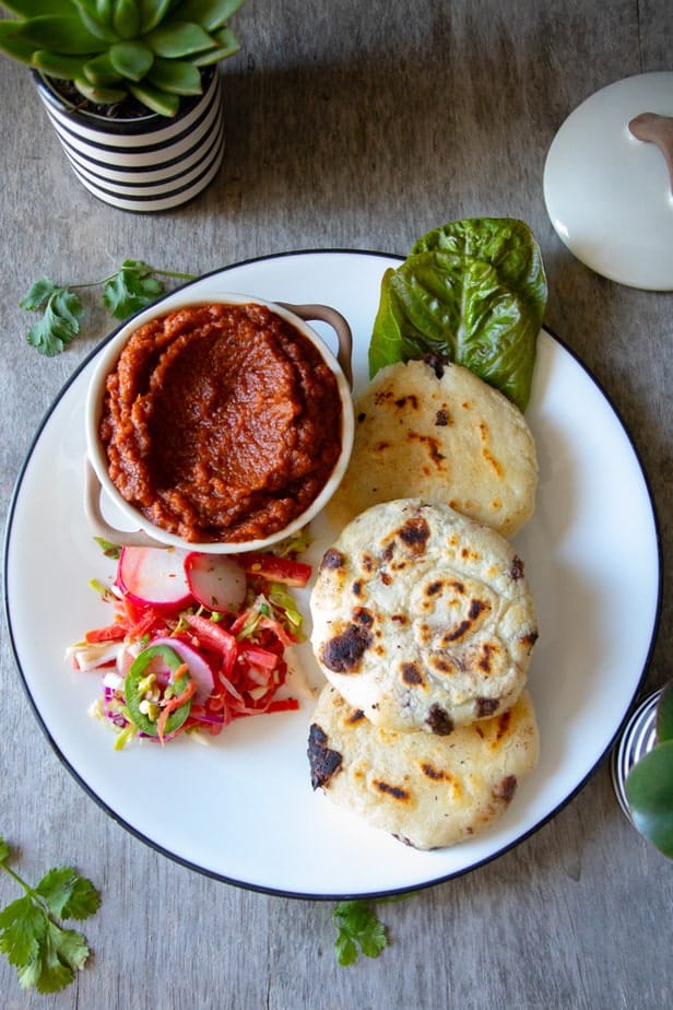 Grilled corn cakes or pupusas with cabbage relish and a roasted tomato salsa