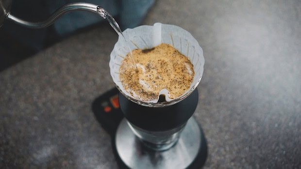 Gooseneck kettle pouring water into a pour over cone