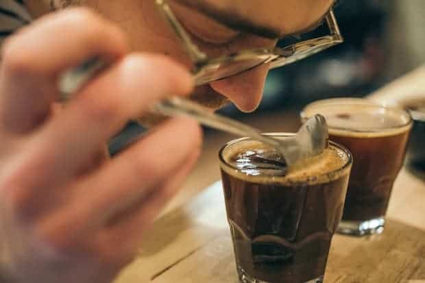 Q grader sniffing a cup of coffee