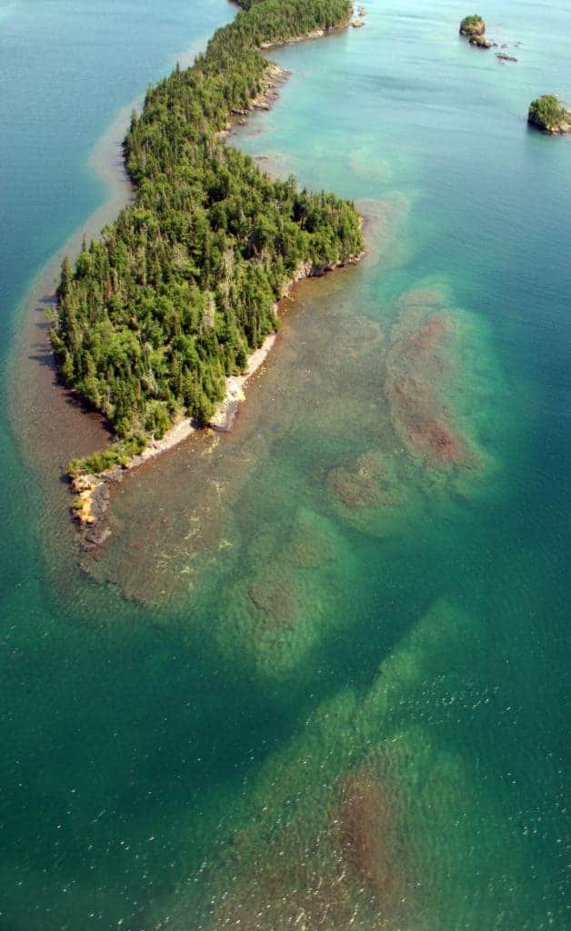 Gneiss shoals can be seen underwater surrounding Shaw Island, just outside Isle Royale National Park, Lake Superior, Michigan.