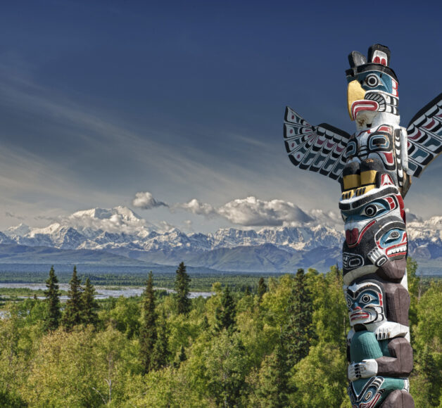 A totem wood pole in mountain background, Vancouver area