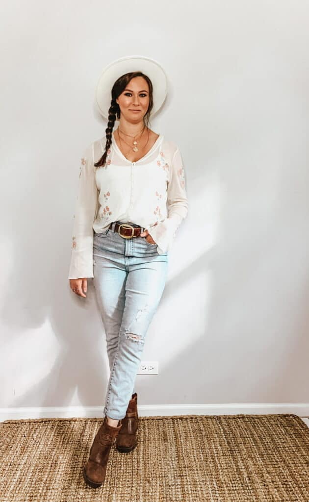 These thrifted fall basics are perfect for all your casual fall outfits. This cream sheer button down blouse with pink and green floral embroidery pairs perfectly with these high rise light wash jeans, a cream hat, a brown belt, and some brown ankle booties.