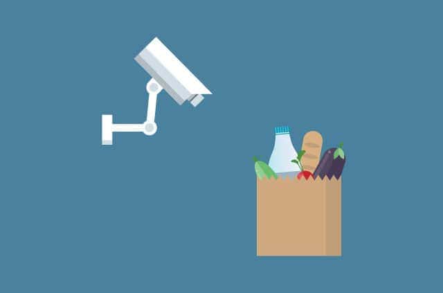 contactless-supermarkets A CCTV camera glares at a grocery bag.