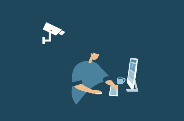 what-is-internet-privacy A person looks at a computer screen as a camera watches from behind.