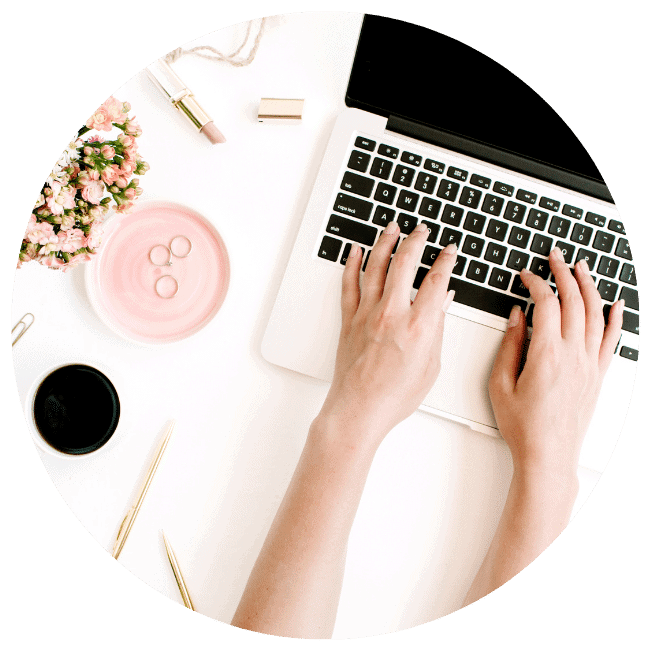 A photo of hands on a laptop keyboard.