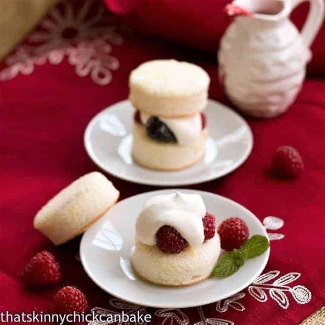 Emeril's Angel Cake Sandwiches - angel food cake rounds filled with berries and cream! Emeril's Angel Cake Sandwiches with and without tops on white plates