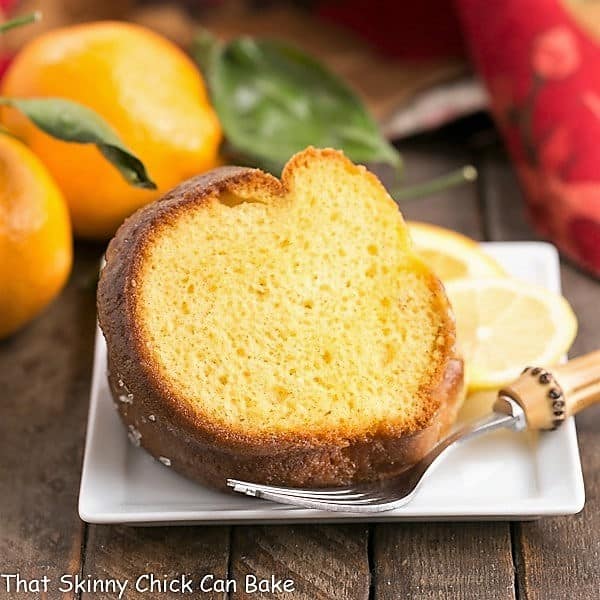 Easy Lemon Bundt Cake - Dense, citrusy and delicious! The shortcut will be our little secret! Easy Lemon Bundt Cake on a square ceramic dessert plate