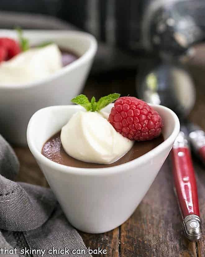 Chocolate Pots de Crème with White Chocolate Whipped Cream - a dreamy chocolate custard to utilize extra egg yolks Chocolate Pots de Creme topped with white chocolate cream and raspberries