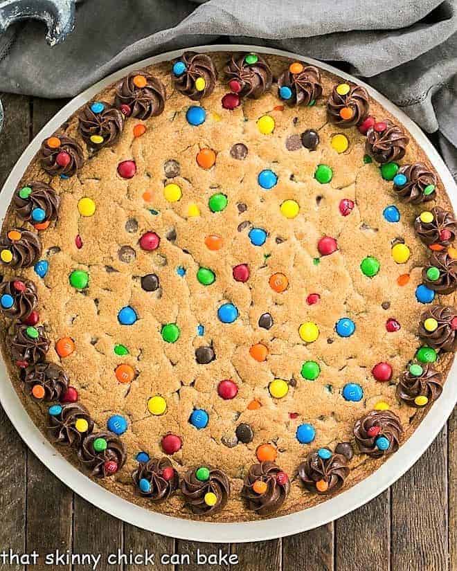 Chocolate Chip Cookie Cake with M&M's - A kid friendly dessert that young and old will be thrilled to eat! Overhead view of chocolate chip cookie cake