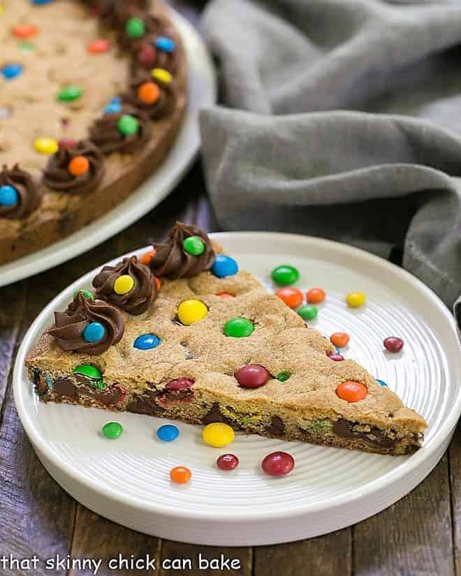 Wedge of chocolate chip cookie cake on a white plate