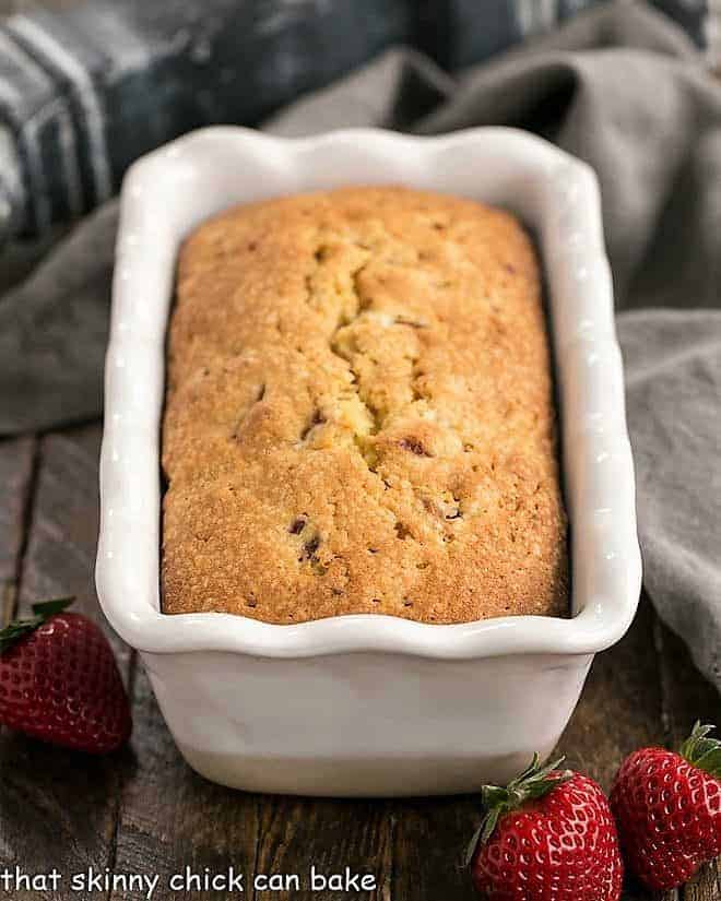 Fresh Strawberry Pound Cake - Dense, delicious, with sweet bits of fresh strawberries! Fresh Strawberry Pound Cake in a white ceramic loaf pan