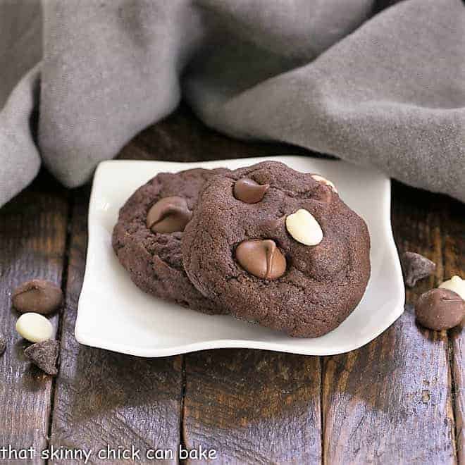 Chewy Quadruple Chocolate Cookies - outrageously delicious and perfect for all the chocoholics in your life! Quadruple Chocolate Cookies on a small, wavy, white plate