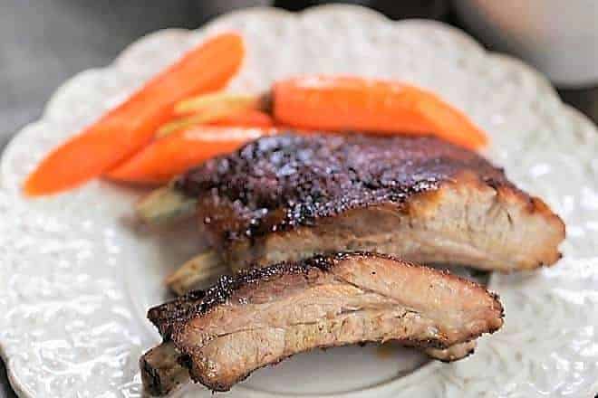 Instant Pot Baby Back Ribs on a white plate with carrots