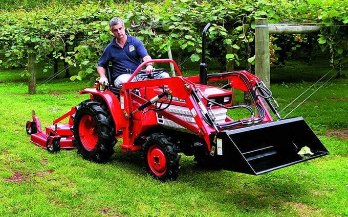 Remanufactured Kubota with front end loader and finishing mower.