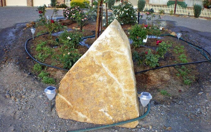 The boulder at the head of the rose garden.