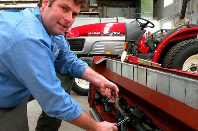 Mark Crakanthorp tightens the bolts on a flail mower.