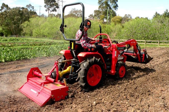 Using a Kubota B1502D with an AGMAX rotary hoe to break up the soil.