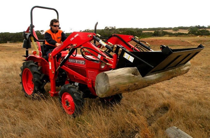 The 4-in-1 bucket is ideal for picking up logs and rocks.